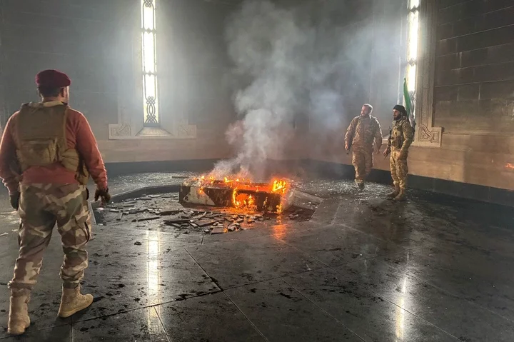 Watch moment cheering Syrian rebels burn COFFIN of Assad's brutal father who slaughtered 40,000 civilians in massacre