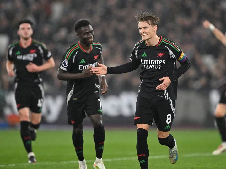 Martin Odegaard celebrates scoring Arsenal's 3rd goal during the Premier League match between West Ham United FC and Arsenal FC at London Stadium o...