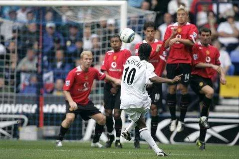 Jay Jay Okocha attempts a free kick against Manchester United.