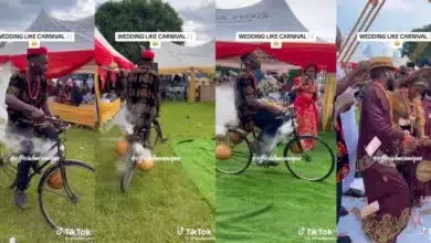 Man makes grand entrance into wedding reception with bicycle and calabash displaying white smoke (Video)