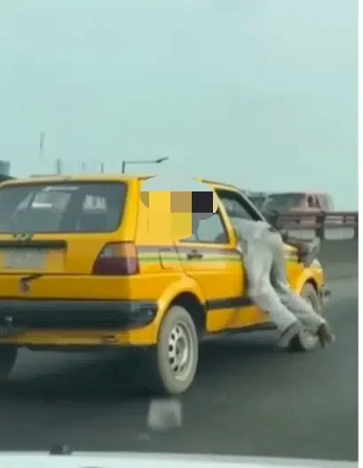 'Lagos is not for the weak' - Reactions as two men cling to moving car in order to settle score with the driver (Video)