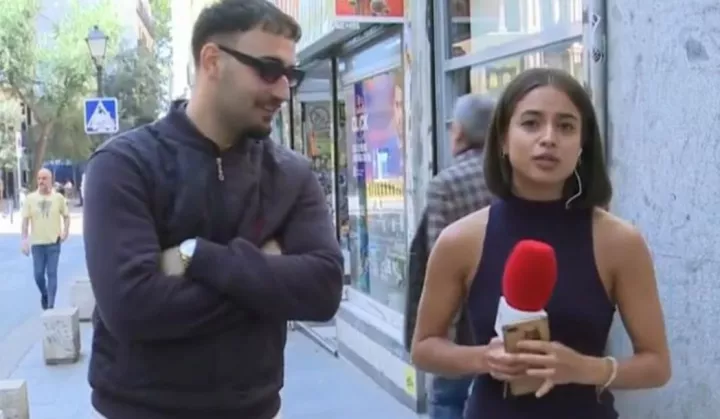 Police arrest man for touching a female reporter's bum on live TV before asking her which television channel she worked for (video)