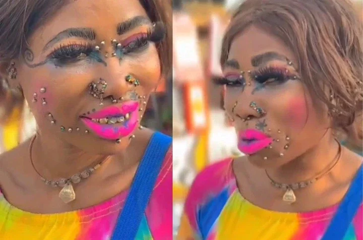 Woman with several piercings on face, coloured teeth & excessive makeup causes stir