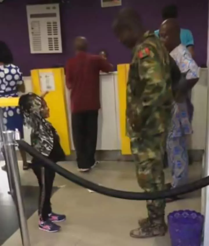 Nigerian soldier reacts as little girl walks up to him inside bank, salutes him (Video)