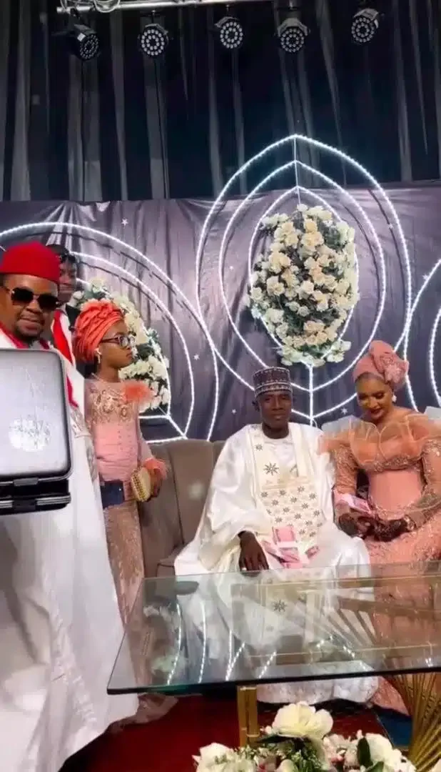 Couple speechless as businessman rains bundles of new notes on them at their wedding (Video)