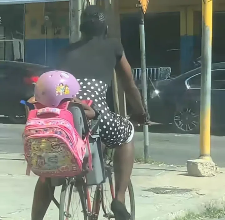 Jamaican supermom raises eyebrows online as she takes daughter to school on a bicycle while wearing high heels