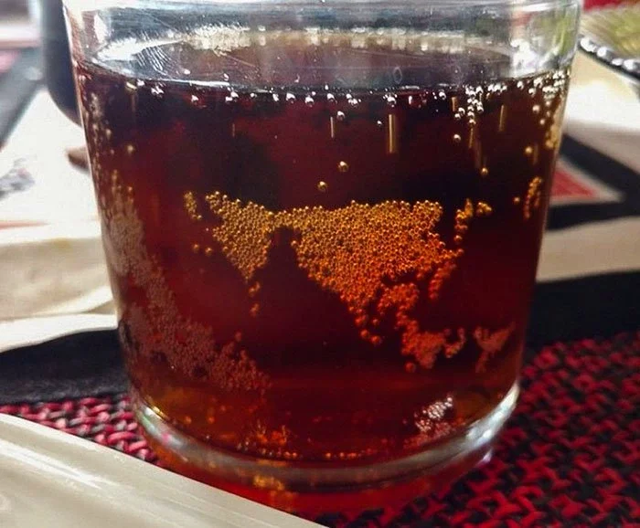 The Bubbles In This Carbonated Drink Resemble A Map Of The World, Showing North And South America