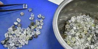 An employee inspects rough diamonds in Alrosa Diamond Sorting Center in the town of Mirny on July 1, 2019.ALEXANDER NEMENOV/AFP via Getty Images