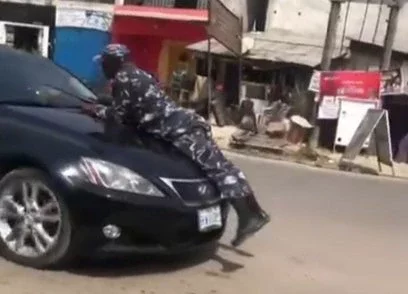 Alleged Yahoo Boy Refuses to Stop, Drives Police Officer On Car Bonnet (Video)