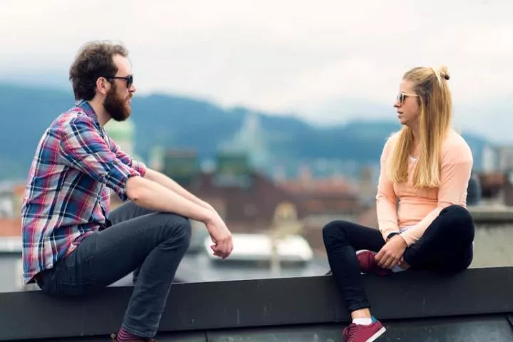 Couple talking on terrace. Photo: Ziga Plahutar Source: Getty Images