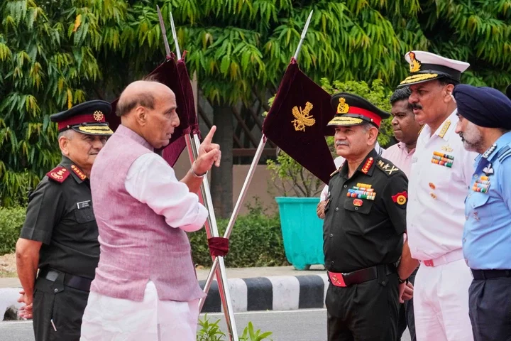Indian Defense Minister Rajnath Singh, second left, talks to three Indian defense chiefs, Army General Upendra Dwivedi, third right, Naval Admiral Dinesh K Tripathi, second right, and Air Force Air Chief Marshal A P Singh, right, as Indian Chief of Defense Staff General Anil Chauhan, left, watches as they wait for the arrival of Japan's Defense Minister Gen Nakatani in New Delhi, India, Monday
