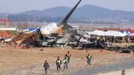 Firefighters and rescue teams work in the aftermath of the crash.<br />Pic: AP/Ahn Young-joon