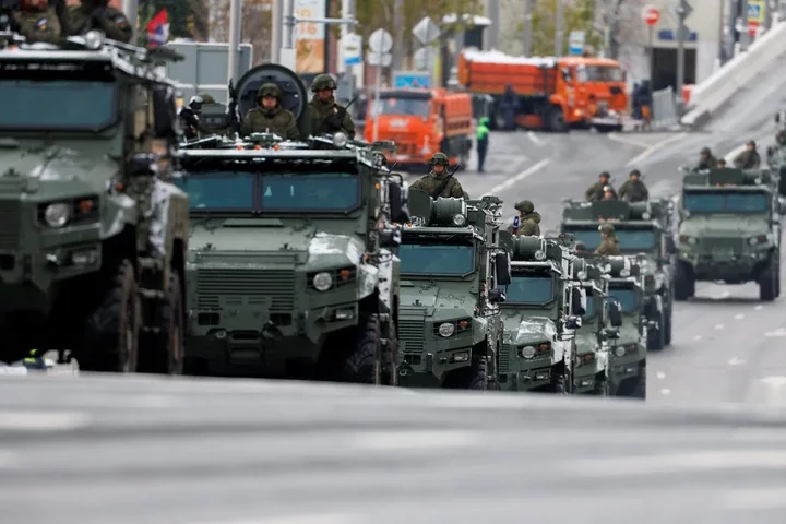 Armoured vehicles rumble through the streets before Putin delivered his speech