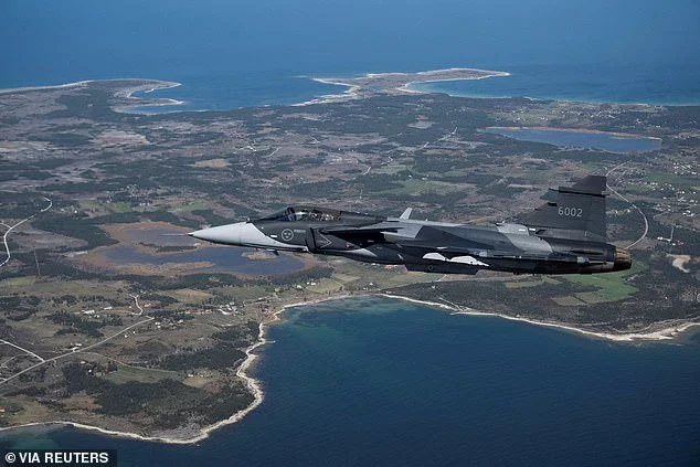 A Swedish JAS 39 Gripen E fighter jet flies over Sweden's Gotland island in the Baltic Sea