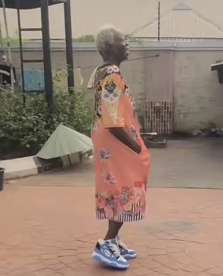 'Pablo mama don come back from UK' - Reactions as old woman stylishly steps out in gown and sneakers