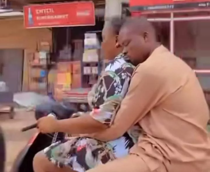 Nigerian man sweetly embraces wife while she drives motorcycle, captures hearts online