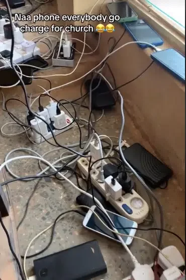 'Phone plenty pass members' - Netizens baffled as video shows phones members brought to charge in church