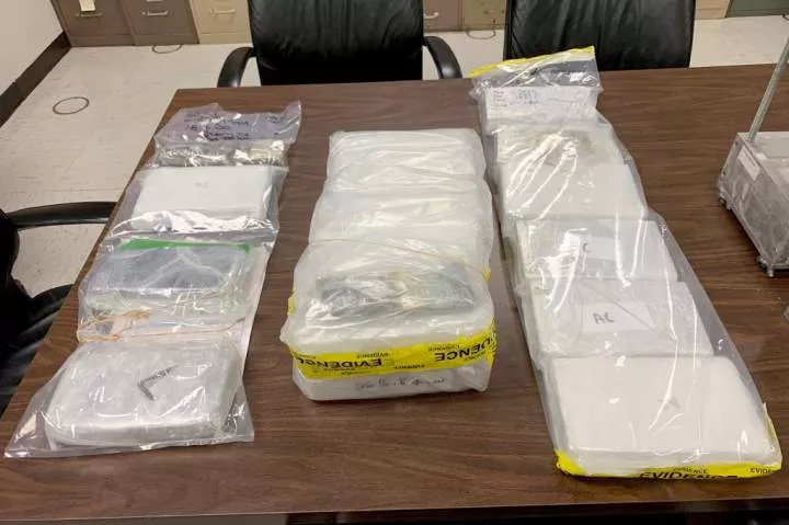 Authorities photographed the bust which included heroin baggies and bricks wrapped in aluminum labeled 'AC'