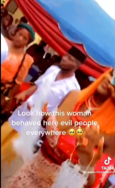 Woman spotted scrubbing a bride's face with money (video)