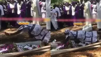 Grief-stricken lady jumps on coffin during burial (Video)