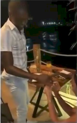 Moment lady proposed to her boyfriend at dinner (Video)