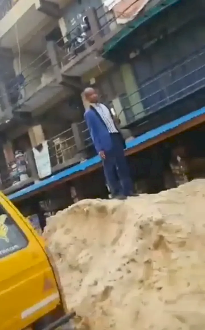 Residents in shock as man climbs heap of sand and repeatedly shouts 'women wicked pass men' (Video)