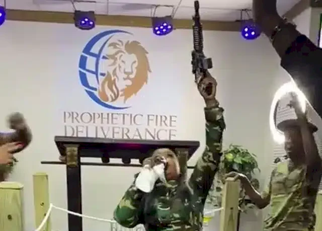 Drama as prophetess wields gun while praying in tongues (Video)