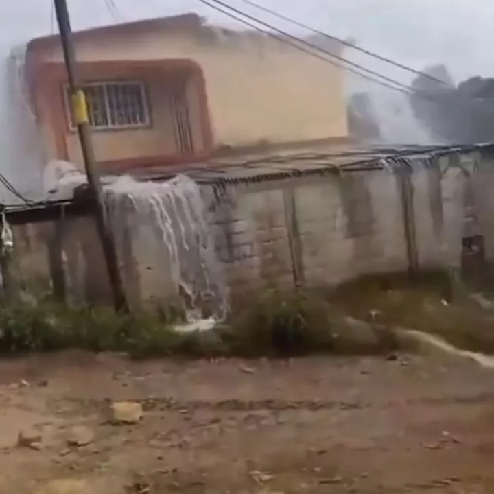 Scary sight as heavy rain falls on one side of the road, other stays dry