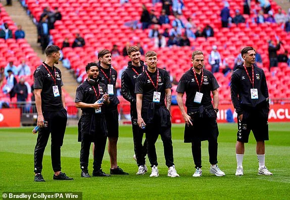 Coventry City players and goalkeeping coach Aled Williams inspect the pitch ahead of the Emirates FA Cup semi-final match at Wembley Stadium, London. Picture date: Sunday April 21, 2024. PA Photo. See PA story SOCCER Coventry. Photo credit should read: Bradley Collyer/PA Wire.RESTRICTIONS: Use subject to restrictions. Editorial use only, no commercial use without prior consent from rights holder.