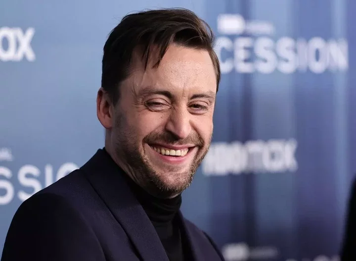 A close up of Kieran smiling on the red carpet