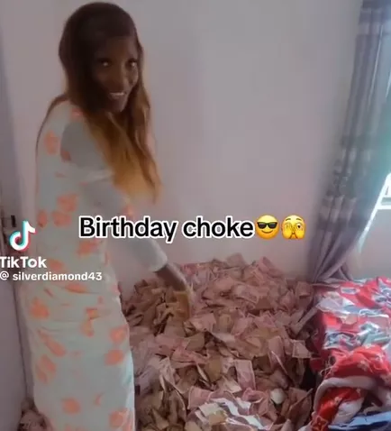Lady shows off money she Lady shows off money she was sprayed on her birthday (Video)