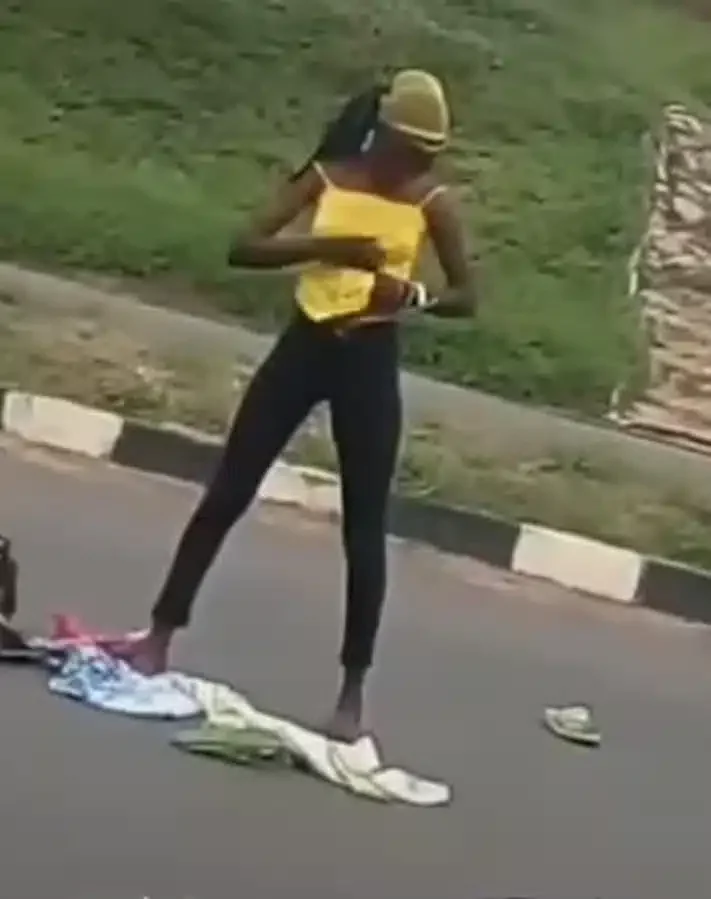 Lady runs mad after being dropped by an alleged yahoo boy in middle of a road (Video)