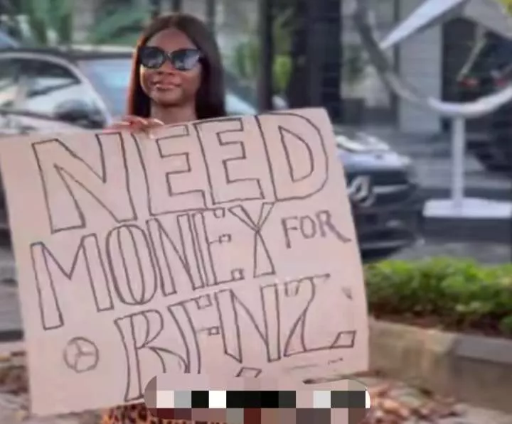 "Need money for Benz" - Nigerian lady storms street with placard, begs for money to buy a brand new Benz