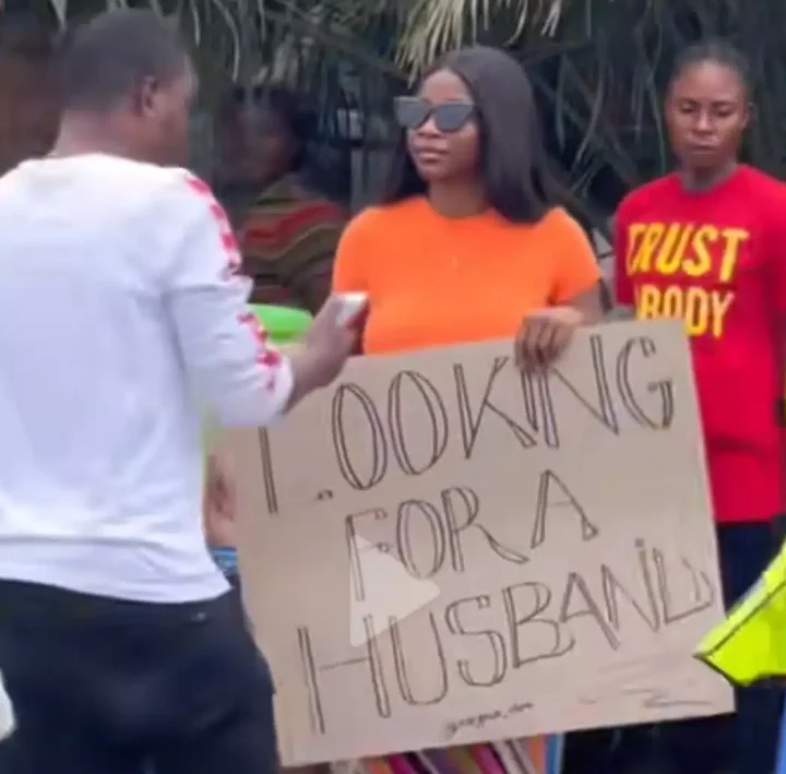 'Looking for a husband' - Lady displays placard, walks into street in search for life-partner (Video)