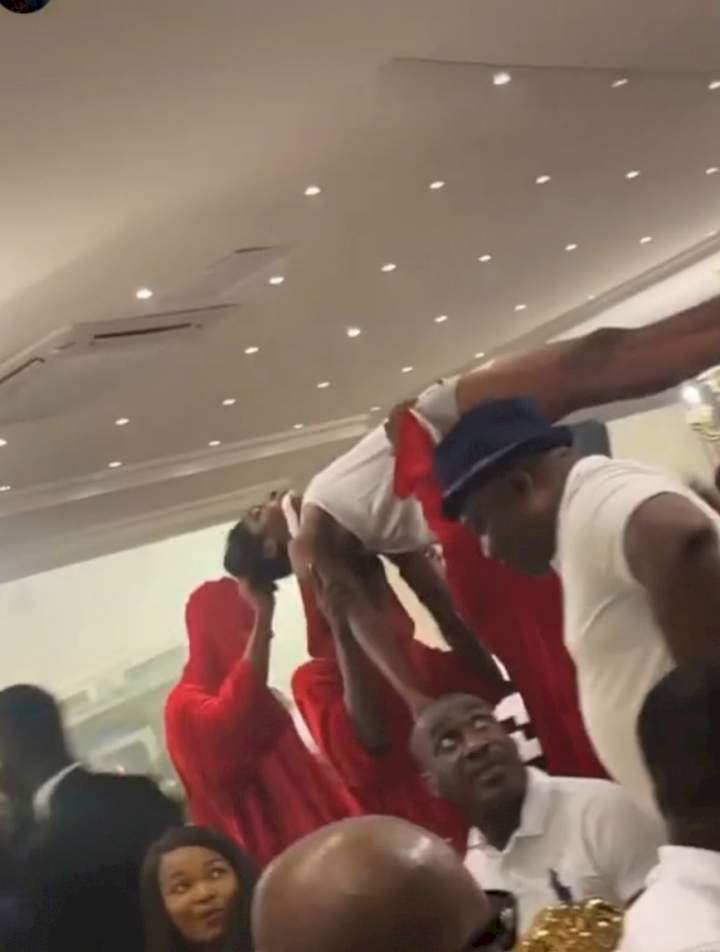 Socialite, Pretty Mike, storms Lagos party with men draped in red attire carrying another man who is almost naked (photos/videos)