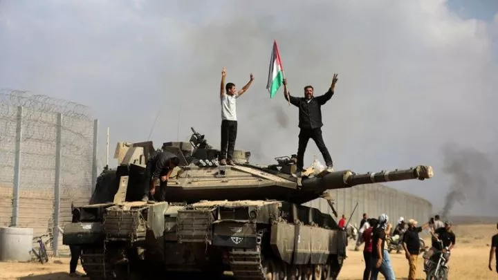 A destroyed Israeli tank at the Gaza Strip fence east of Khan Younis. Pic: AP