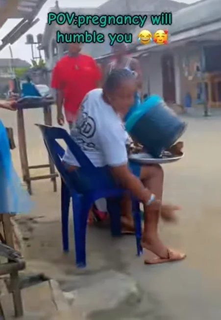 'Pregnancy will humble you' - Moment a pregnant woman drinks 'garri' using a food cooler (Watch)