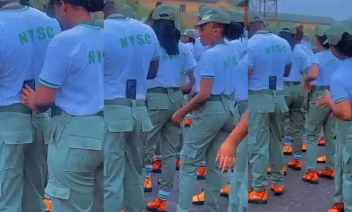 "Una don turn grown man to ring light" - Reactions as female NYSC corpers use man as a tripod stand for video