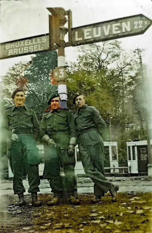 SAS soldiers seen posing by a road sign in Belgium, as they make their way towards Nazi Germany