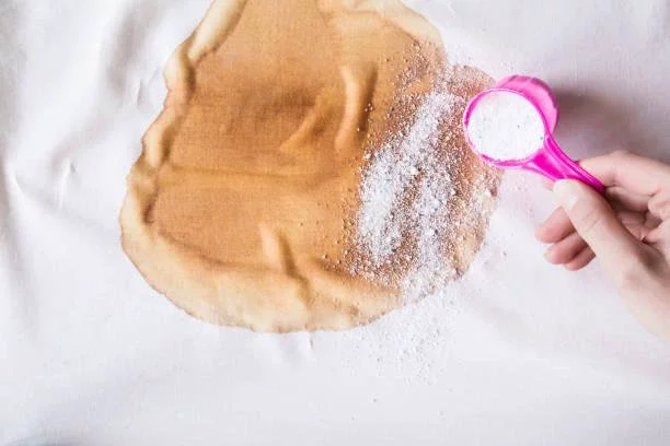 Apply salt or baking soda to stubborn stains 