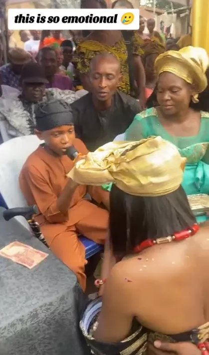 Emotional moment as bride's little brother represents late father, couple kneel before him for blessings at wedding