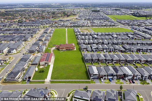 The home is surrounded by around 750m of fencing to hold back the burgeoning and ongoing construction work erupting around them