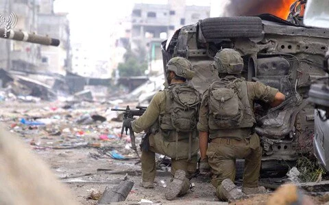 Israeli soldiers take positions during the ongoing ground operation against Palestinian Islamists