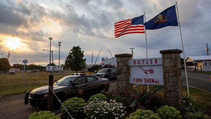 A state trooper car blocks the entrance to the event grounds where the rally was held