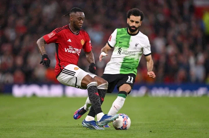 Mohamed Salah of Liverpool challenges Aaron Wan-Bissaka of Manchester United during the Emirates FA Cup Quarter Final match between Manchester Unit...