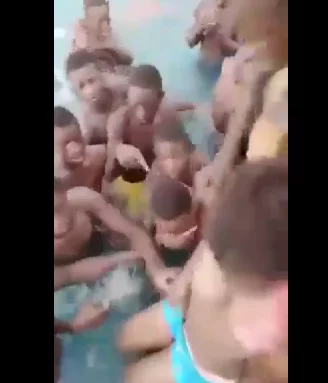 Boys fondle and grope helpless girl in a crowded pool (video)