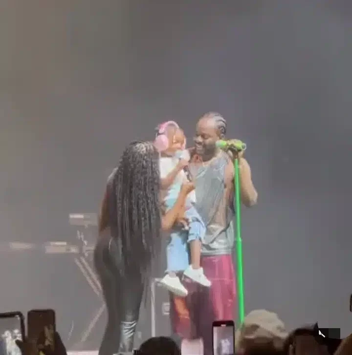 Adorable moment Simi and daughter surprise Adekunle Gold on stage (Video)