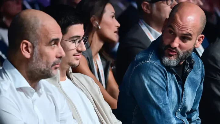 Manchester City coach, Pep Guardiola with his son, Marcus and brother, Pere during a conference. Photo by Marco BERTORELLO.