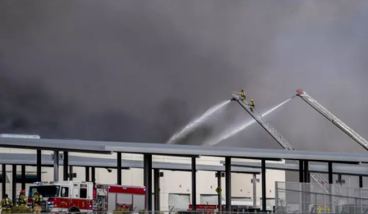 Seven injured as firefighters battle inferno after explosion near US airport