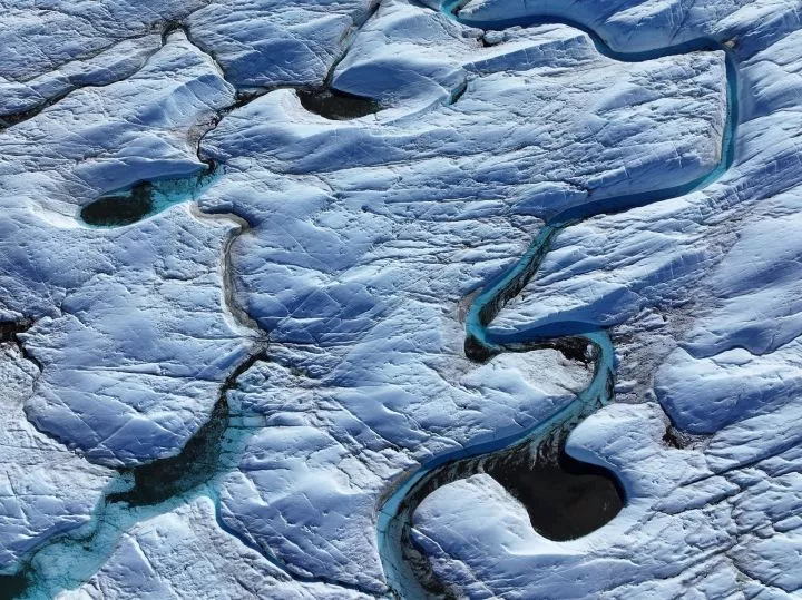 Rivulets of meltwater snake across the surface of the melting Isunnguata Sermia glacier of the Greenland Ice Sheet on July 11, 2024 near Kangerlussuaq, Greenland. 